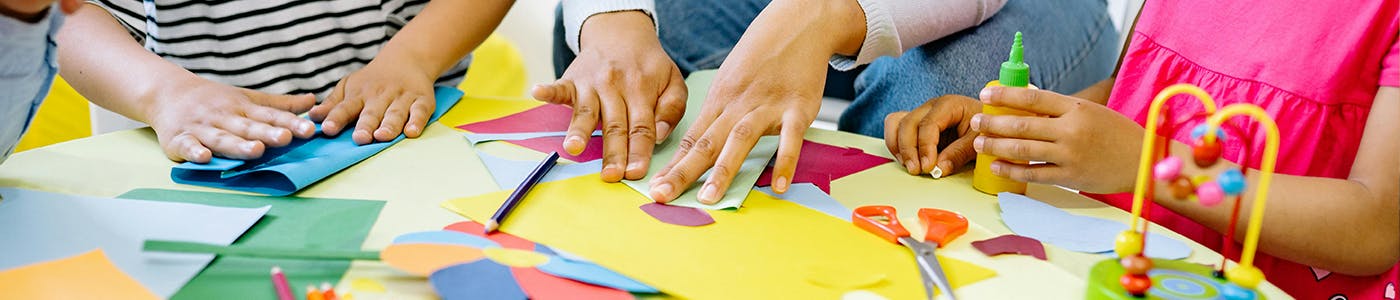 children's and a teachers hands doing art